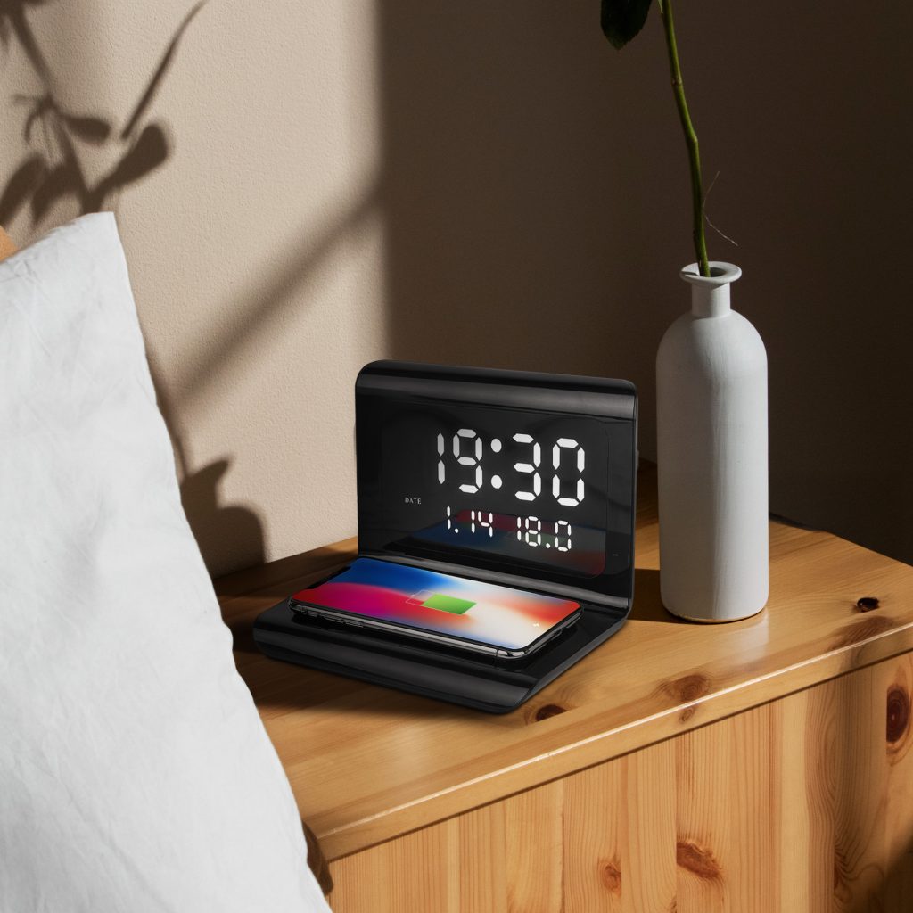 image of the wireless charger with alarm clock on a bedside table