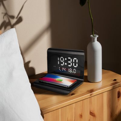 image of the wireless charger with alarm clock on a bedside table